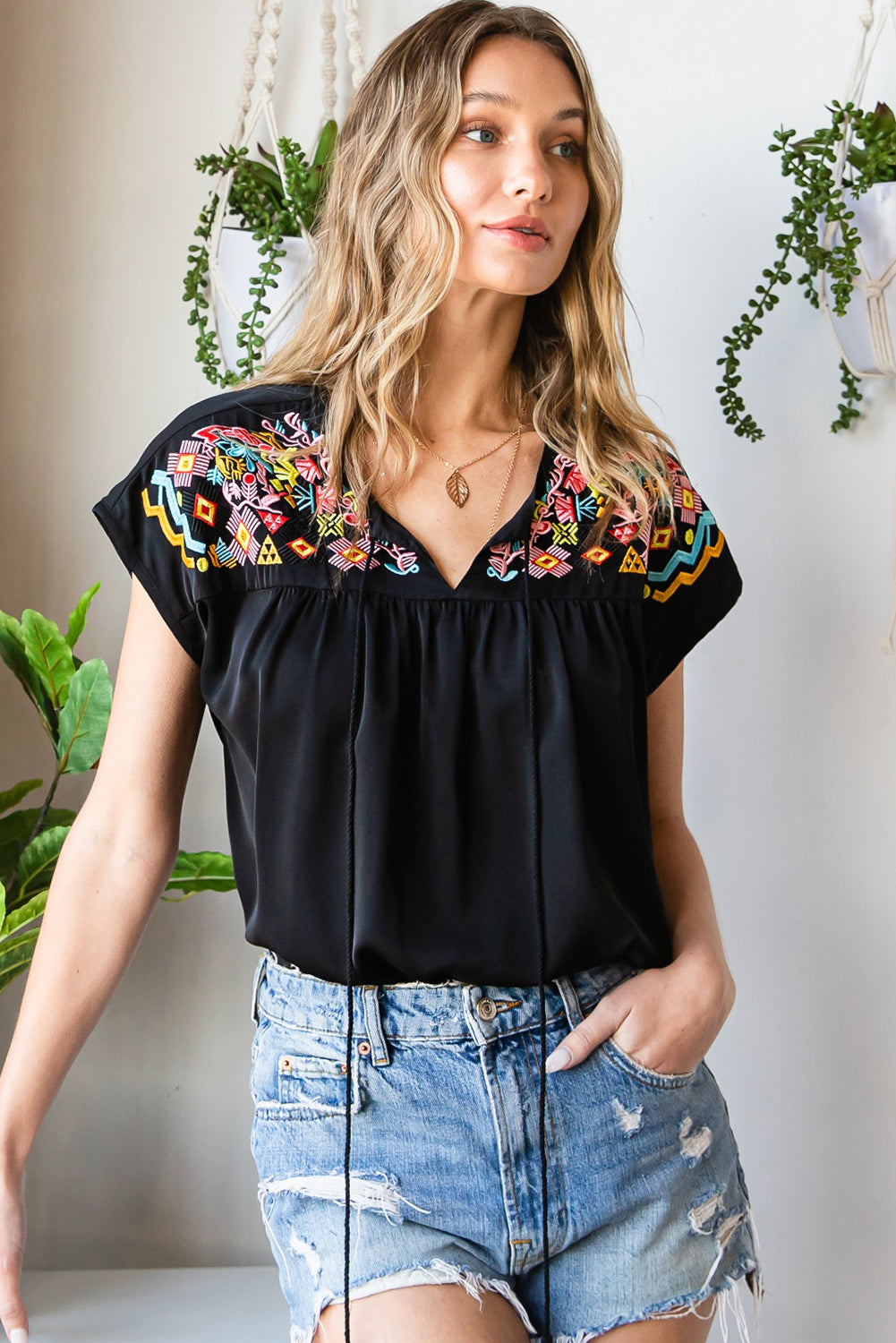 Blusa de manga curta bordada com flor geométrica preta